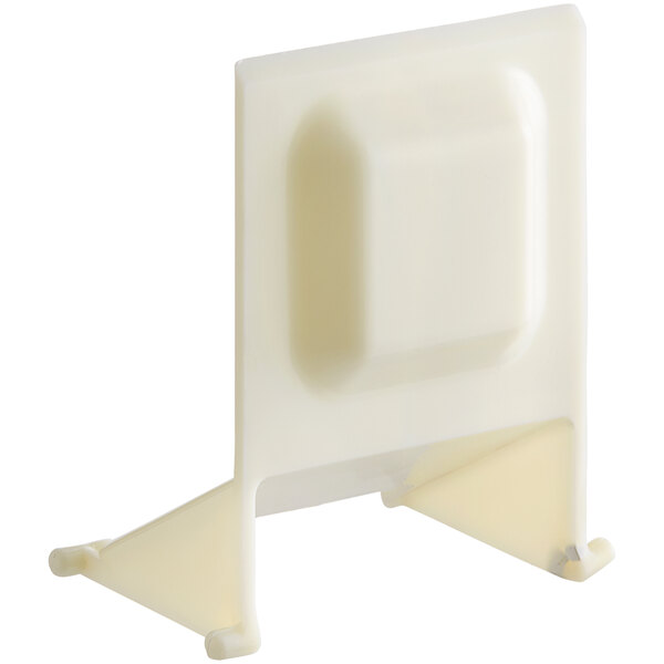 A white plastic Avantco ice chute door holder with a square object on it.