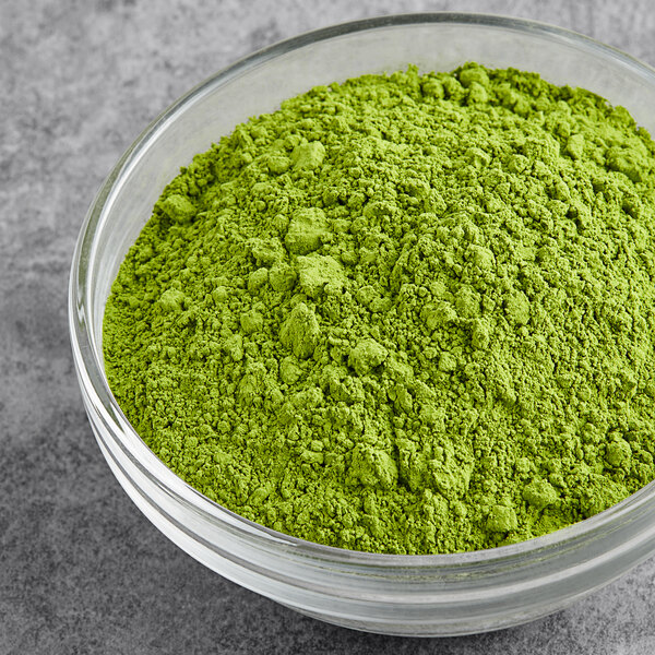 A bowl of Tenzo Organic Ceremonial Matcha powder on a table.