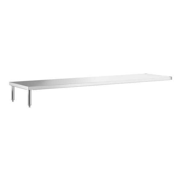 A long, rectangular stainless steel shelf with four metal legs, designed to be placed under a larger table.