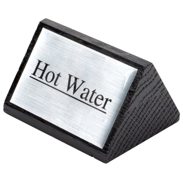 A black and silver American Metalcraft wood "Hot Water" sign on a counter.