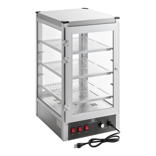 A rectangular glass and metal display case with three perforated shelves, a front door, control switches, and a power cord.