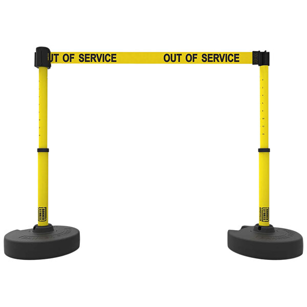 Two yellow and black Banner Stakes retractable barriers with "Out of Service" signs.