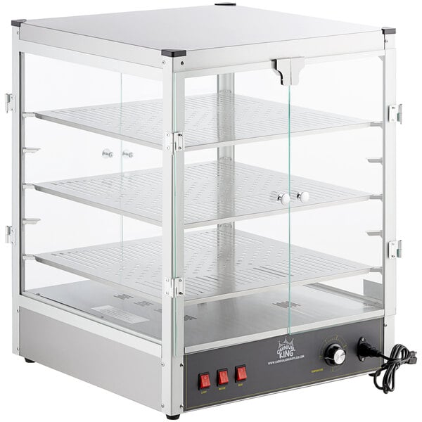A Carnival King countertop warmer with a glass door and shelves.