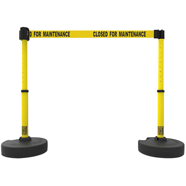 Two yellow and black Banner Stakes safety tape stands.