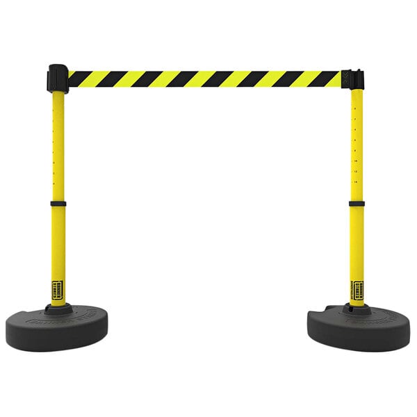 A Banner Stakes yellow and black striped retractable barrier with black poles.