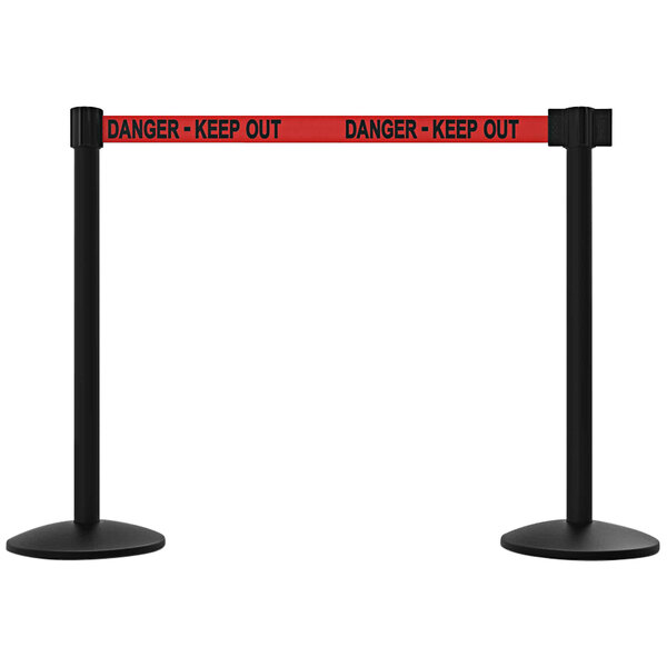 A pair of red and black Banner Stakes safety barriers with "Danger - Keep Out" signs on them.