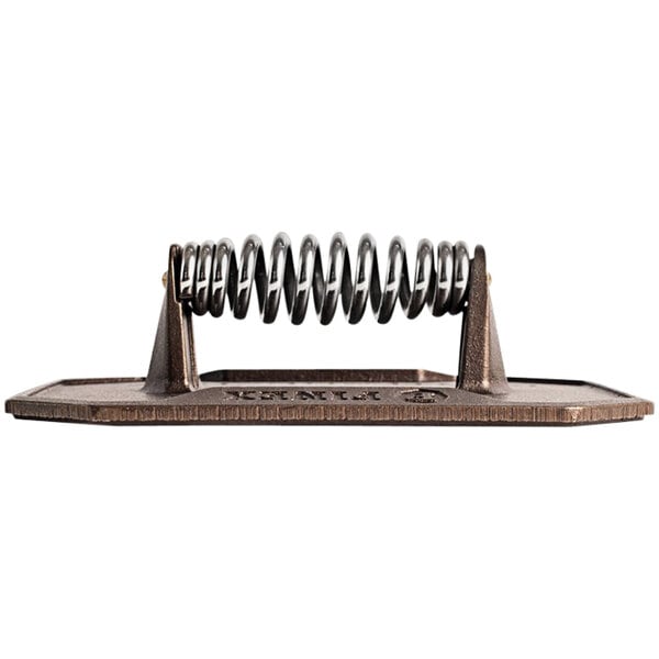 A FINEX cast iron flat press on a metal surface.