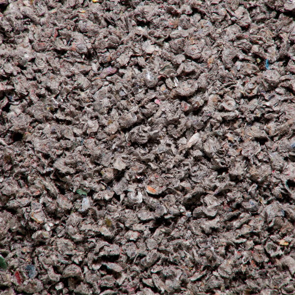 A pile of loose, gray absorbent material used for soaking up spills.