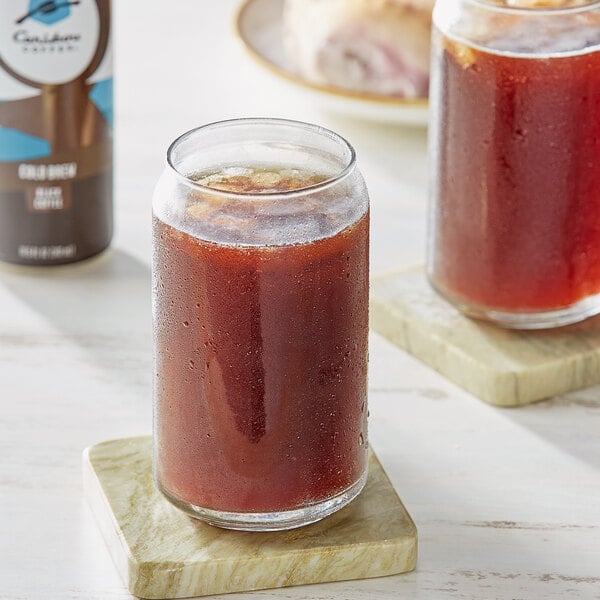 A glass of Caribou cold brew coffee on a marble coaster.