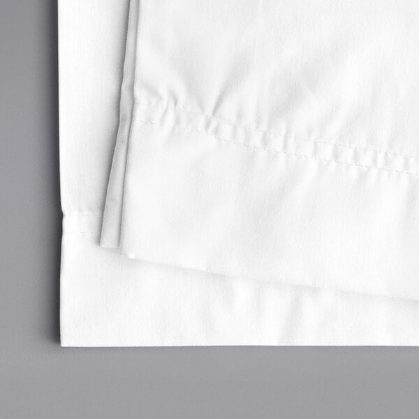 A white folded Oxford Superblend pillow case on a gray surface.