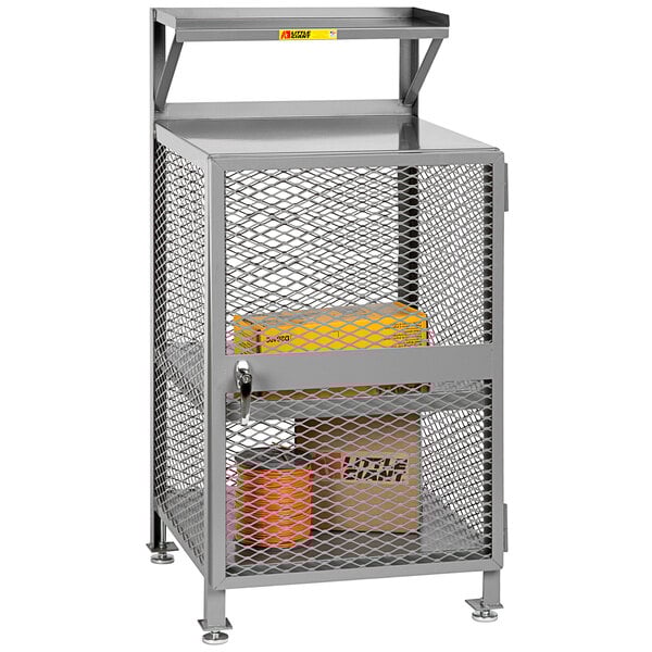 A Little Giant enclosed steel shop desk with shelves over a yellow box inside.