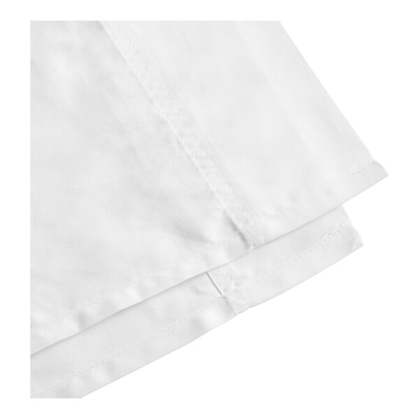 A close-up of a white cotton flat sheet with visible stitching along the edge.