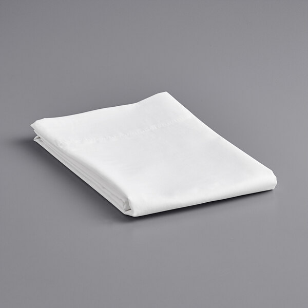 A folded white Welspun Hygrocotton T400 sateen pillow case on a gray surface.