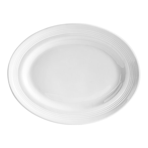 A white Tuxton oval china platter with a thin curved rim.