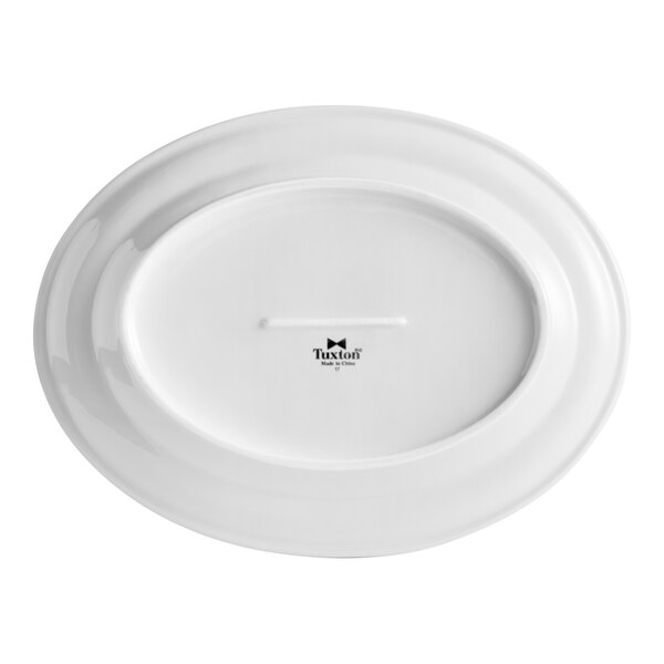 A white oval china platter with a black rim and a white surface.