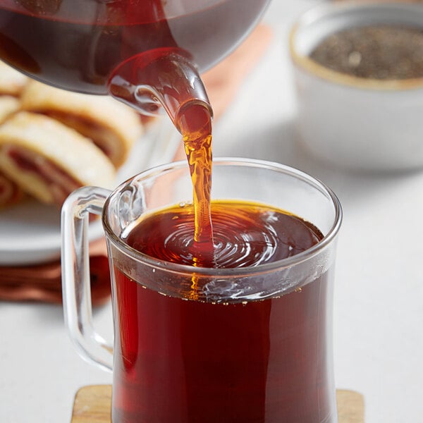 A glass mug filled with ChaTraMue Thai black tea.