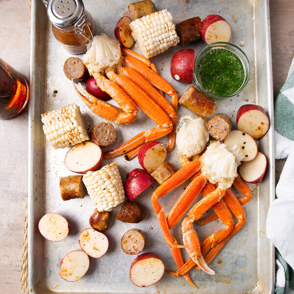 A tray of Chesapeake Crab Connection snow crab legs with potatoes and corn.