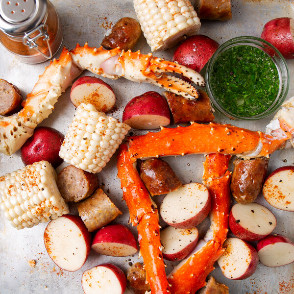A tray of Chesapeake Crab Connection Alaskan King Crab legs with potatoes and corn.
