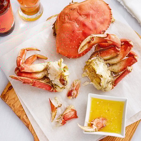 The claws of a Chesapeake Dungeness crab on a paper towel next to a glass of beer.