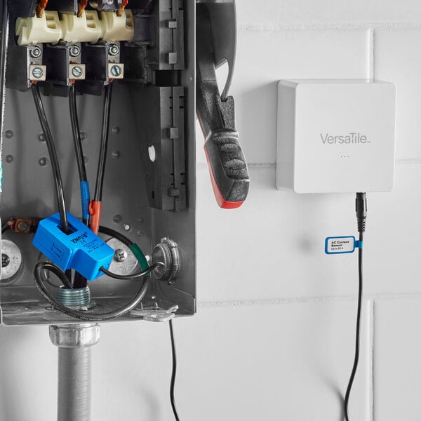 A white VersaTile Electric Current Sensor clamp box with wires and cables.