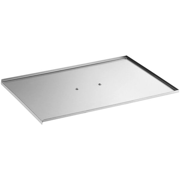 A silver rectangular stainless steel cover with a screw in the middle.