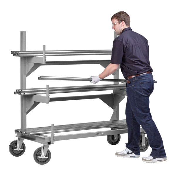 A mobile fully welded steel cantilever rack with three shelves and four caster wheels, designed for heavy-duty storage and transport.