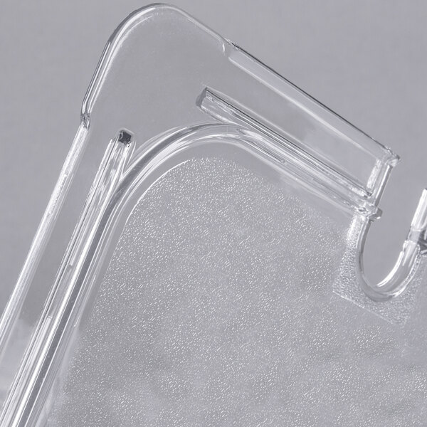 A clear plastic Carlisle container lid with a spoon notch.