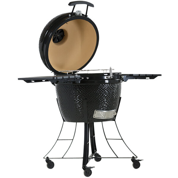 A Pit Boss black ceramic round barbecue grill with the lid open on a table.