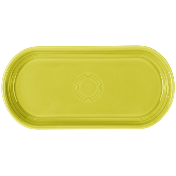 A yellow oval Fiesta china bread tray with a circle in the middle.