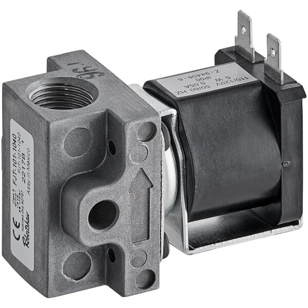 A close-up of a black and silver mechanical device with a metal valve inside.