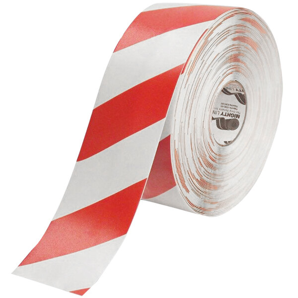 A roll of white tape with red chevrons and red and white stripes.