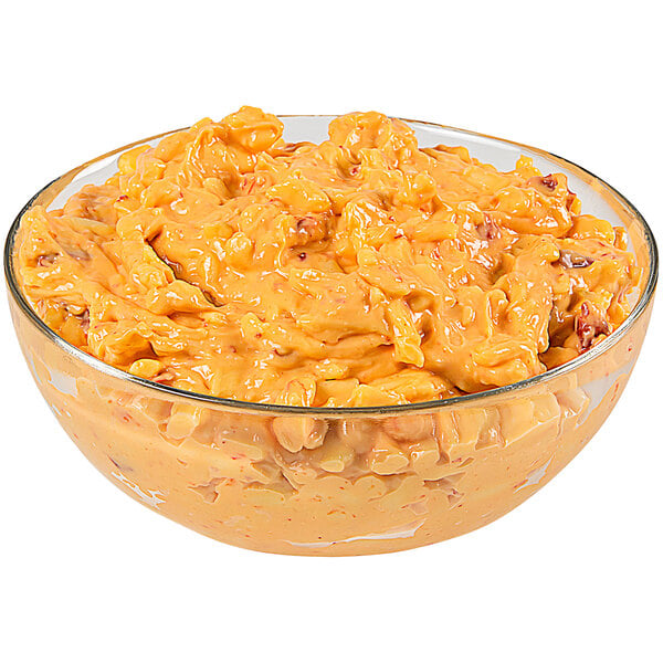 A glass bowl of Price's Pimento Cheese Spread on a table in a deli.
