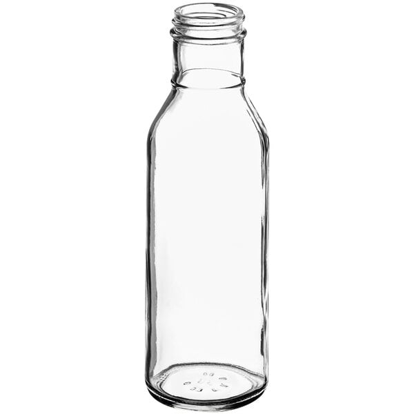 A clear glass Ring Neck dressing bottle with a lid.
