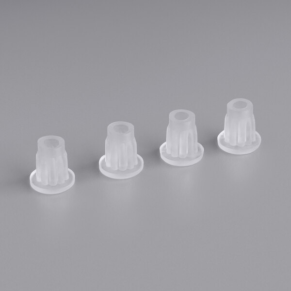 Three clear plastic caps on a white surface.