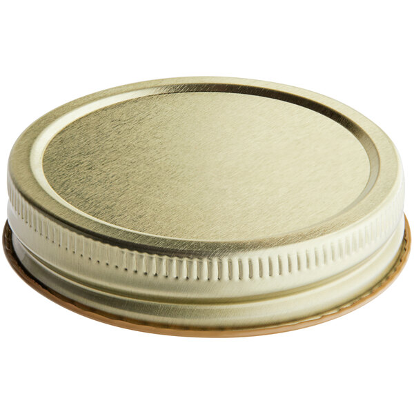 A 70/450 gold metal lid with a ring on top.