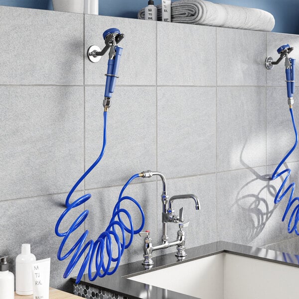 A Waterloo pet grooming faucet with blue hoses and a coiled faucet.