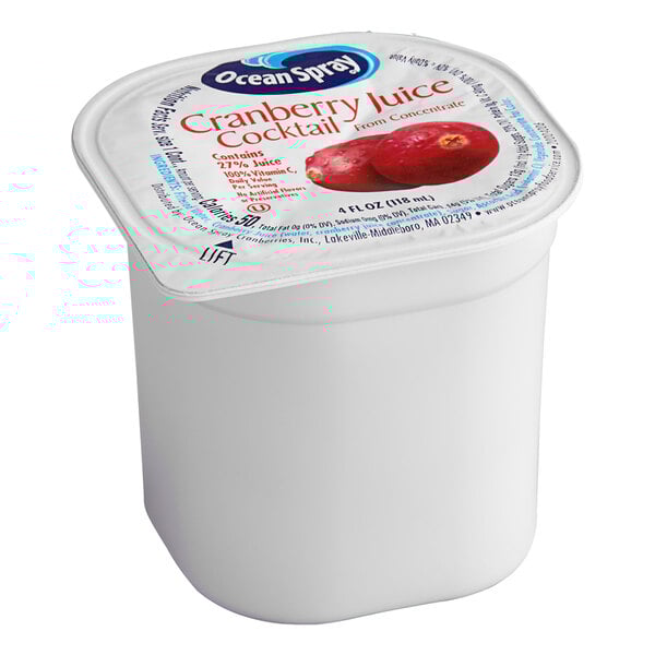 A case of Ocean Spray cranberry juice cocktail cups with a white label on a white container.