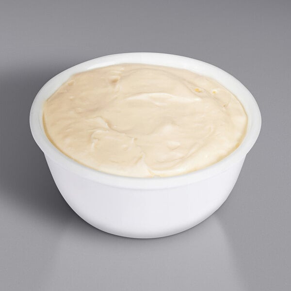 A white bowl of Philadelphia cheesecake batter.