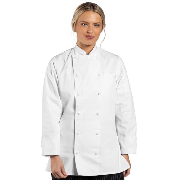 A woman wearing a white Uncommon Chef long sleeve chef coat.