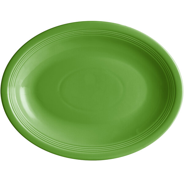 An Acopa Capri palm green stoneware oval coupe platter with a rim and circle in the middle on a white background.