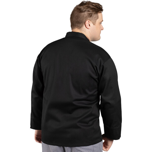 A man wearing a black Uncommon Chef long sleeve chef coat.
