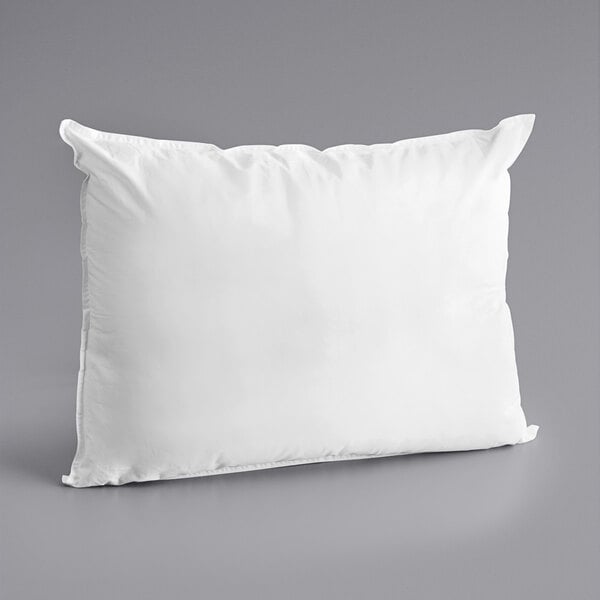 An Oxford Diamond white king size pillow on a gray surface.