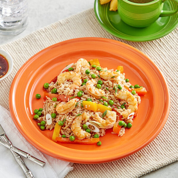 An Acopa Capri stoneware plate with rice, shrimp, and vegetables on a table.