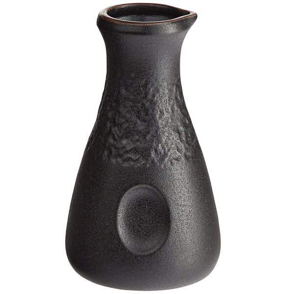 An Acopa Heika black stoneware sake bottle with a round neck and textured matte finish.
