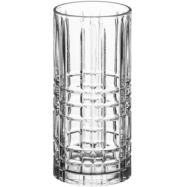 A close-up of an Acopa clear beverage glass with a checkered pattern.