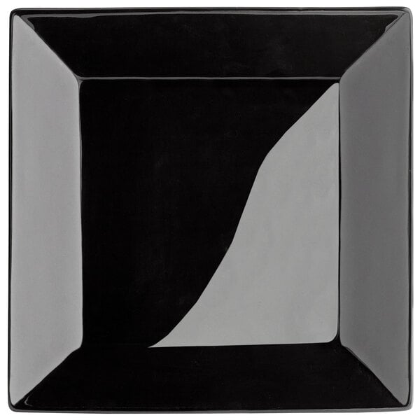 A glossy black stoneware square plate with a black rim.