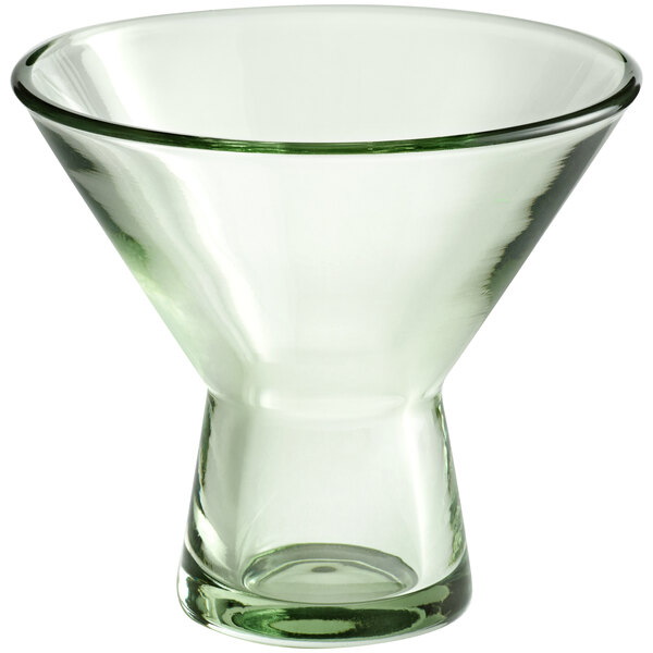 A close-up of an Acopa Pangea green martini glass with a clear bottom and rim.