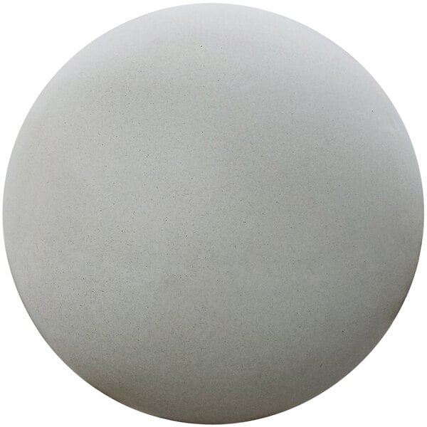 A white concrete sphere with black specks.