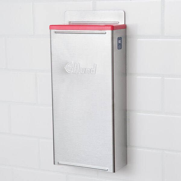 An Edlund stainless steel knife rack with red insert.