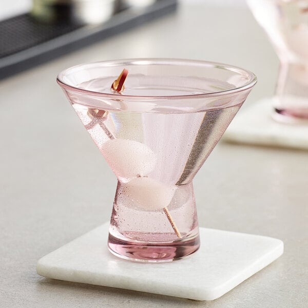 Two mauve Acopa martini glasses on a counter.